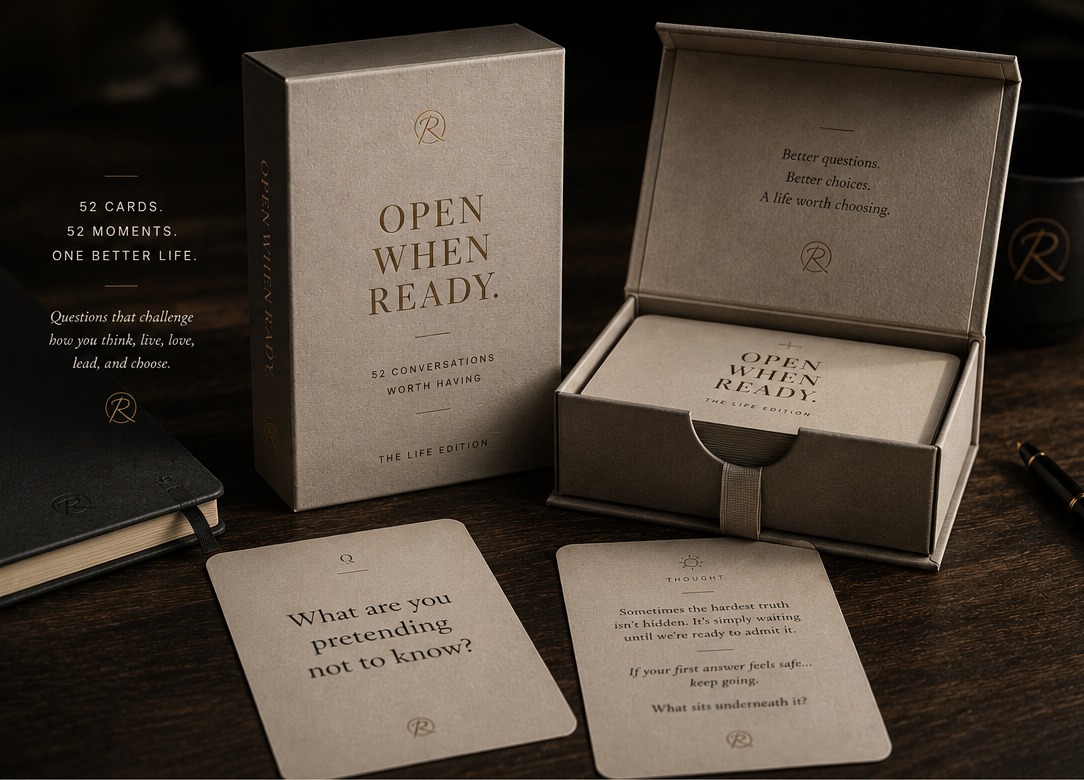 The Questions Deck, Life Edition, an open keepsake box with cards reading Open When Ready and two question cards on a dark wood table